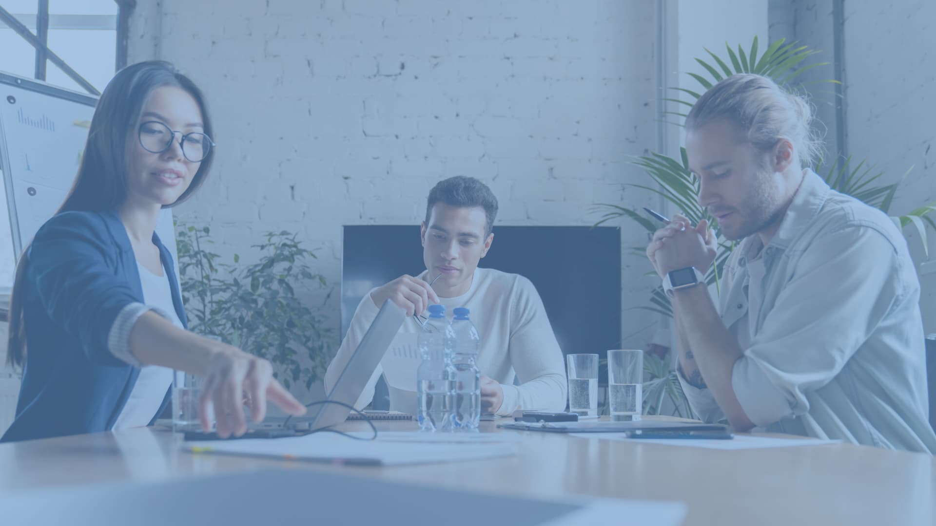 women and men on a meeting table